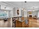 Open floor plan kitchen featuring hardwood floors, island and stainless steel appliances at 308 Lismore Ter, Woodstock, GA 30189