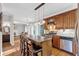 A lovely kitchen with a granite island, stainless appliances, and hardwood floors, seamlessly connected to the living room at 308 Lismore Ter, Woodstock, GA 30189
