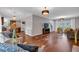 Bright and airy living room showcasing hardwood floors, recessed lighting, neutral colors, and a seamless flow to the kitchen at 308 Lismore Ter, Woodstock, GA 30189