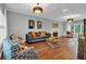 A bright living room boasts hardwood floors, recessed lighting, a fireplace, and large windows with plantation shutters at 308 Lismore Ter, Woodstock, GA 30189