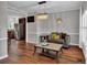 Open-concept room with hardwood floors, a modern sofa, and a view into the kitchen at 308 Lismore Ter, Woodstock, GA 30189