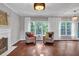 Bright living room featuring hardwood floors, large windows and white trim at 308 Lismore Ter, Woodstock, GA 30189