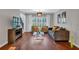 Cozy living room featuring hardwood floors, large windows, and modern furniture at 308 Lismore Ter, Woodstock, GA 30189