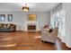 Bright living room featuring hardwood floors, with fireplace and modern furniture at 308 Lismore Ter, Woodstock, GA 30189