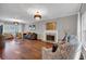 Open living room featuring hardwood floors, with fireplace and modern furniture at 308 Lismore Ter, Woodstock, GA 30189