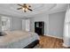 Main bedroom features a tray ceiling, hardwood floors, neutral paint, and ensuite bath access at 308 Lismore Ter, Woodstock, GA 30189