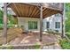 Covered patio area under a wood deck creates an outdoor living space at 308 Lismore Ter, Woodstock, GA 30189