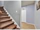 Stairwell featuring carpeted steps and hardwood flooring at 308 Lismore Ter, Woodstock, GA 30189
