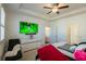 Spacious bedroom featuring a tray ceiling, television, dresser, and a modern chair at 351 Clay St, Grayson, GA 30017