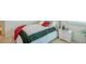 Bedroom featuring neutral decor and a comfortable bed with green and red accents at 351 Clay St, Grayson, GA 30017