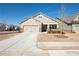 Well-maintained home with a large driveway and attractive landscaping on a sunny day at 351 Clay St, Grayson, GA 30017