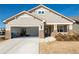 Home with a two-car garage, stone accents, and a welcoming front porch showing the garage open at 351 Clay St, Grayson, GA 30017