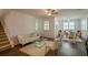 Living area with hardwood floors, modern furnishings, and a glass-topped coffee table at 351 Clay St, Grayson, GA 30017