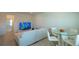Open living space with a white sofa, television, and a glass table with chairs at 351 Clay St, Grayson, GA 30017