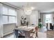 Bright dining room features a modern light fixture and a rustic wooden table set for a meal at 1908 Stanton Rd, East Point, GA 30344