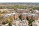 Aerial view of brick apartment buildings in a wooded setting with well-kept grounds and parking areas at 2300 Peachford Rd # 4004, Atlanta, GA 30338
