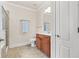 Neutral toned bathroom with a wooden vanity, tile flooring, and a combined shower and tub at 2300 Peachford Rd # 4004, Atlanta, GA 30338