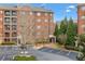 Condo building with brick facade, multiple balconies, and a well-maintained parking area at 2300 Peachford Rd # 4004, Atlanta, GA 30338