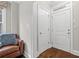 Inviting foyer with hardwood floors, a leather chair, and white doors at 2300 Peachford Rd # 4004, Atlanta, GA 30338