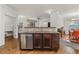 An open-concept kitchen with island featuring stainless steel appliances and dark wood cabinets at 2300 Peachford Rd # 4004, Atlanta, GA 30338