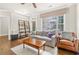 Cozy living room featuring hardwood floors, a comfortable couch, and a large window at 2300 Peachford Rd # 4004, Atlanta, GA 30338