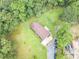 Aerial view of a cozy house surrounded by lush trees, a well-kept lawn, and a private driveway at 5255 Post Rd, Winston, GA 30187