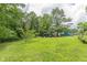 Vast backyard with plenty of space for gardening or recreation, surrounded by lush trees and greenery at 5255 Post Rd, Winston, GA 30187
