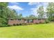 Classic brick home with a welcoming porch and colorful shutters, set on a sprawling green lawn at 5255 Post Rd, Winston, GA 30187