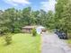 Beautiful brick home with a long driveway and plenty of parking space, surrounded by mature trees and green lawn at 5255 Post Rd, Winston, GA 30187