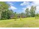 Well-kept brick home with bright shutters and a lush green lawn, nestled among mature trees at 5255 Post Rd, Winston, GA 30187