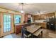 Eat-in kitchen features wood cabinets, updated appliances, and a breakfast table with seating at 5255 Post Rd, Winston, GA 30187