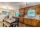 Eat-in kitchen with wooden cabinets, stainless steel appliances and windows allowing for natural light at 5255 Post Rd, Winston, GA 30187