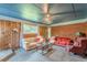Inviting living room featuring wood paneling, brick accents, and comfortable seating, creating a cozy atmosphere at 5255 Post Rd, Winston, GA 30187