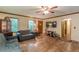Spacious living room with hardwood floors, ceiling fan, neutral paint, and ample natural light at 5255 Post Rd, Winston, GA 30187
