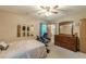 Comfortable main bedroom featuring a ceiling fan, dresser and mirrors at 5255 Post Rd, Winston, GA 30187