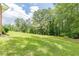 Expansive green lawn with mature trees surrounding the property, providing shade and privacy at 5255 Post Rd, Winston, GA 30187