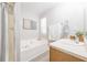 Bright bathroom featuring a soaking tub, stand-up shower, and a vanity with storage at 2720 Marlin Dr, Mcdonough, GA 30253