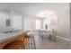 Open-concept dining and kitchen area with bar seating and a cozy dining set for four at 2720 Marlin Dr, Mcdonough, GA 30253