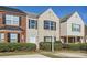 Traditional townhome with manicured landscaping and contrasting brick and beige facade at 2720 Marlin Dr, Mcdonough, GA 30253