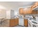 Bright kitchen showcasing wood cabinets and modern white appliances at 2720 Marlin Dr, Mcdonough, GA 30253