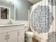 Bathroom with a white vanity, sink, toilet, and shower with a patterned curtain at 3465 Jones Ferry Ln, Alpharetta, GA 30022