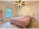 Comfortable bedroom with a ceiling fan, a large window, and a pink color scheme at 3465 Jones Ferry Ln, Alpharetta, GA 30022