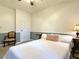 Bedroom with a classic chair, side tables, white bedding and door to another room at 3465 Jones Ferry Ln, Alpharetta, GA 30022