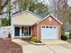 Charming single-Gathering home featuring a well-manicured lawn, brick accents, and attached garage at 3465 Jones Ferry Ln, Alpharetta, GA 30022
