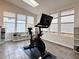 Bright fitness room with skylight, tiled floors, floor-to-ceiling windows, and workout equipment at 3465 Jones Ferry Ln, Alpharetta, GA 30022