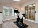 Tiled fitness room features workout equipment, ample natural light, and access to the home's interior at 3465 Jones Ferry Ln, Alpharetta, GA 30022