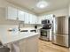 Modern kitchen featuring stainless steel appliances, quartz countertops, and bright white cabinetry at 3465 Jones Ferry Ln, Alpharetta, GA 30022