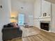 Cozy living area featuring a fireplace, comfortable seating, and ample natural light at 3465 Jones Ferry Ln, Alpharetta, GA 30022