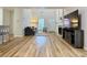 Inviting living room featuring hardwood floors, a cozy sofa, and a modern entertainment center at 3465 Jones Ferry Ln, Alpharetta, GA 30022