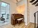 Inviting living room featuring a grand piano, bright windows, and an adjacent fitness area at 3465 Jones Ferry Ln, Alpharetta, GA 30022